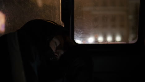 tired boy in moving car at night