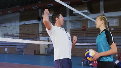 male coach assisting volleyball player 4k