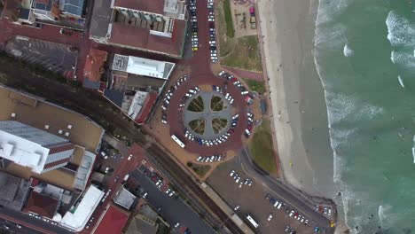 birds eye drone shot of muizenberg, cape town - drone is descending over the famous surfers corner