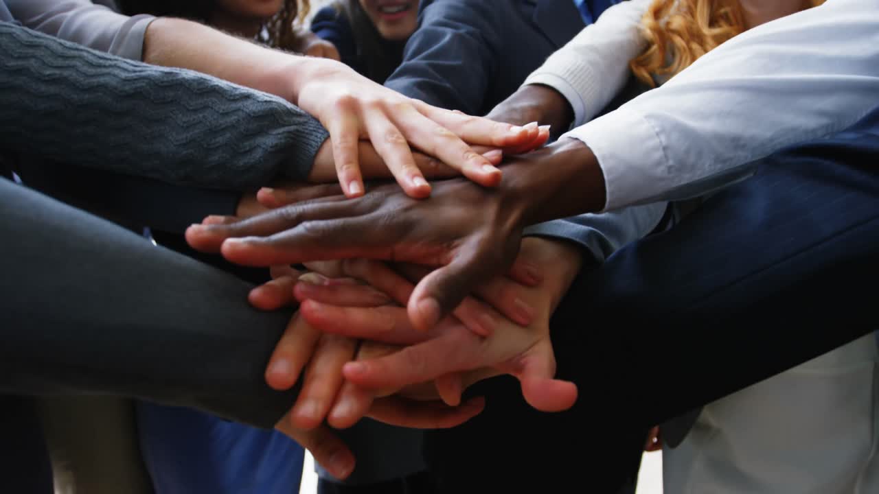 Businesspeople forming hands stack