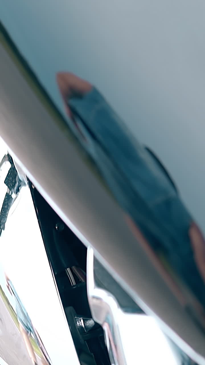 wonderful close view black and silver modern motorbike reflects walking man in denim dressing image