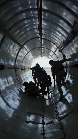military personnel training in aircraft tunnel