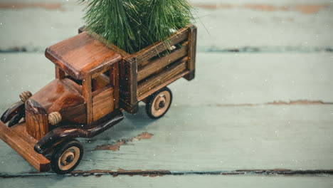 model car with a fir on its roof combined with falling snow