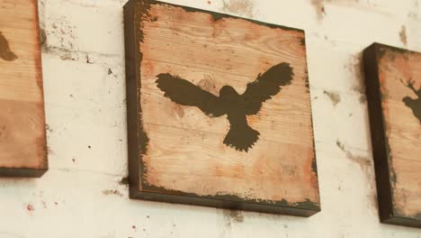 wooden signs depicting bear, bird, and moose