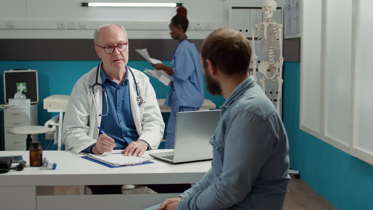 Senior doctor attending health examination with young adult