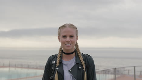 portrait-of-gritty-blonde-woman-removes-sunglasses-smiling-wearing-leather-jacket