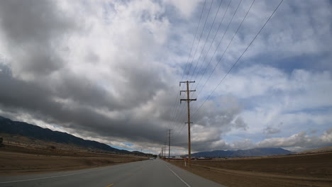 Driving-through-a-rural-area-in-the-mountainous-Mojave-Desert---driver-point-of-view-hyper-lapse