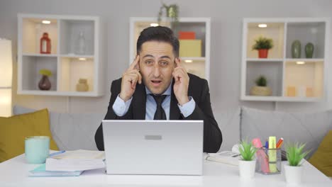 home office worker man coming up with idea looking at camera.