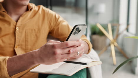 man using smartphone and notebook