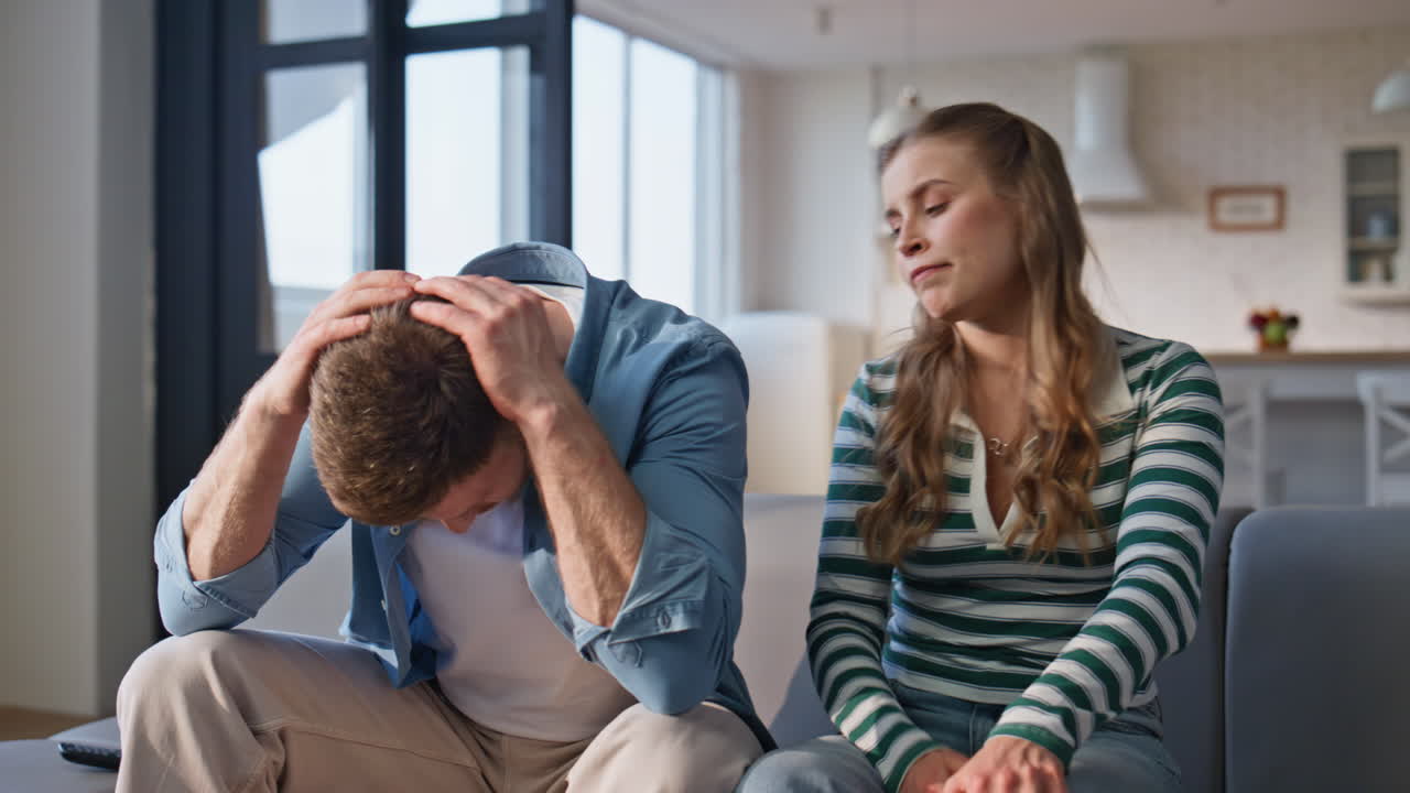 Involved couple supporting football home closeup. Lovers watching sport game