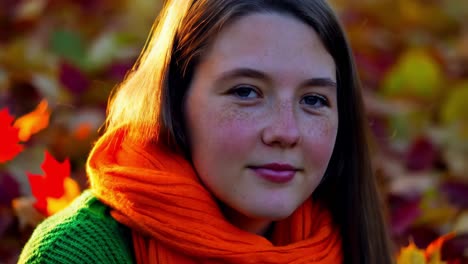 teenage girl in autumn leaves