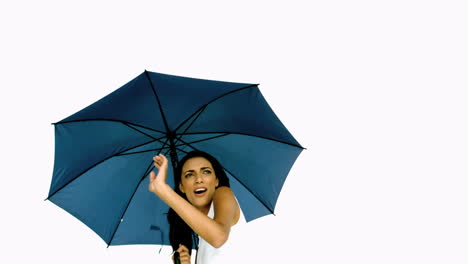 Pretty-woman-under-blue-umbrella-cowering-with-fear