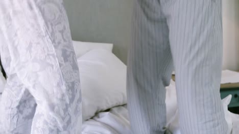 senior couple dancing on bed