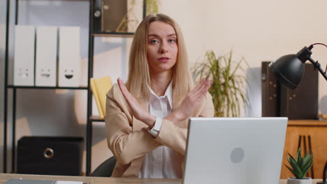 mujer de negocios trabajando en una computadora portátil que muestra gesto de parada, peligro, advertencia de rechazo, crisis, prohibición