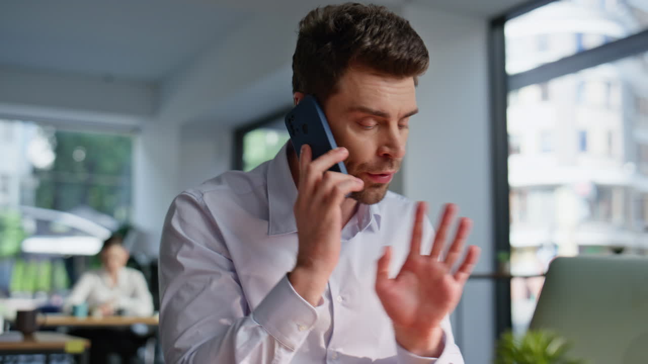 Nervous boss talking smartphone complaining on bad work sitting office closeup