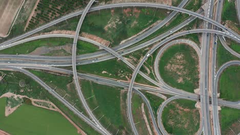 aerial drone accent large road intersection highway from high altitude, modern city traffic car move