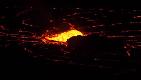 lava fountain flowing rapidly at night at kilauea volcano, hawaii