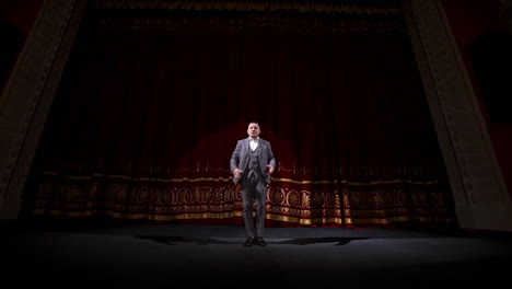 showman dances on a stage. senior male entertainer, presenter or actor on stage. selective focus on a male in suit.