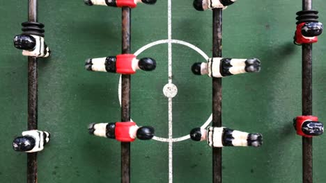 foosball or fuzboll overhead top angle view live table soccer world cup football game match day leisure time competition sports battle overview goal win ball vintage retro games green pitch no offside