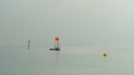 view of the sea from barcelona beach with sailboats in the water in slow motion