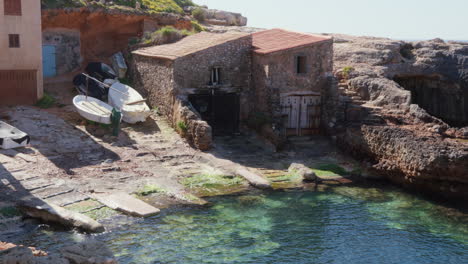 a boat shed by the turquoise waters in mallorca, a typical scene bathed in sunshine, showcasing the local charm