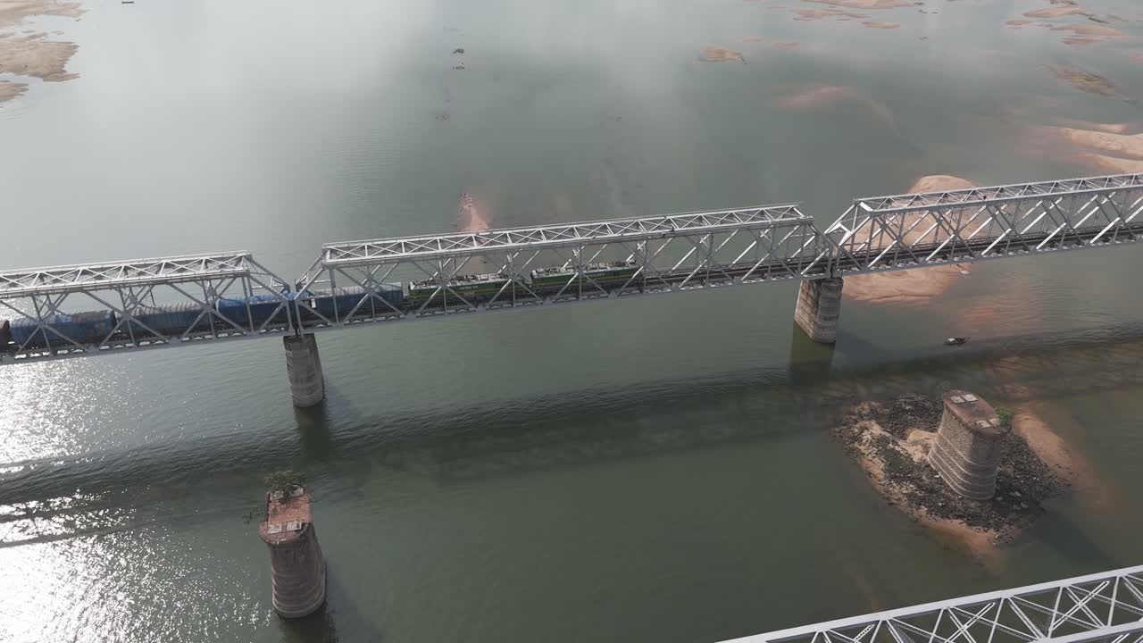 Train Crossing a River Bridge: Aerial View