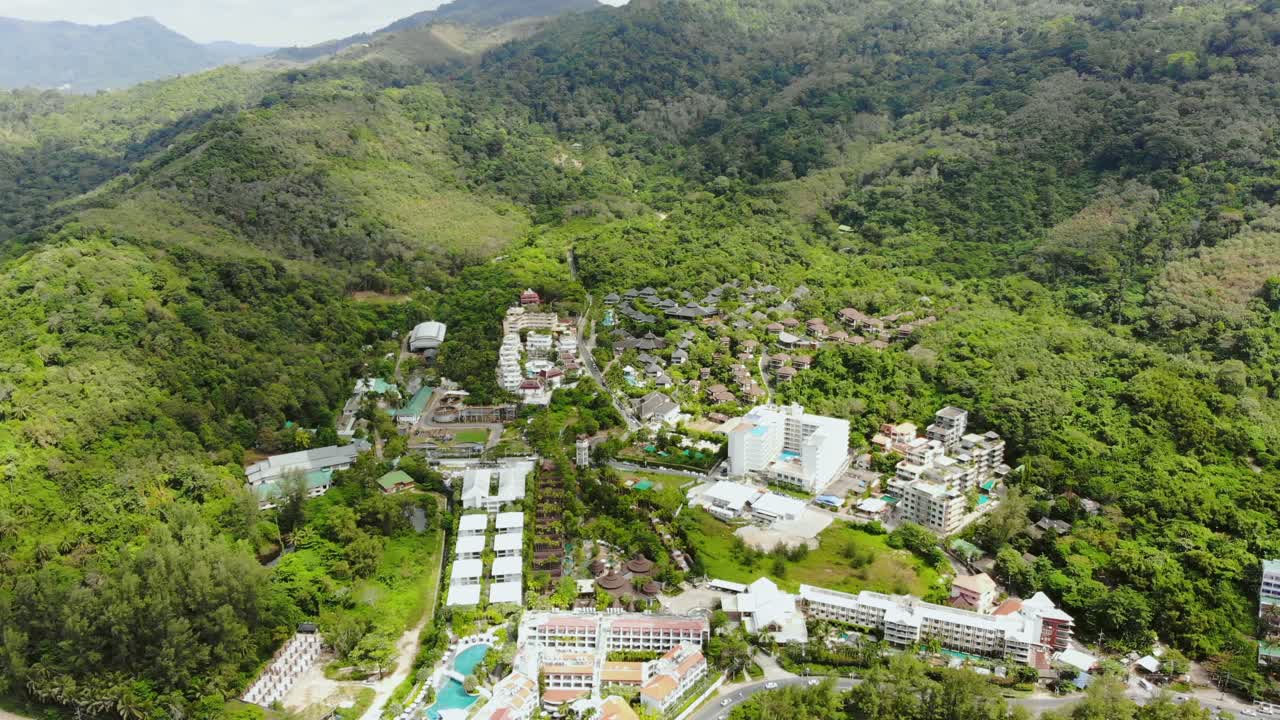 Aerial View Over Hotel Resorts Nestled In Forested Landscape In Phuket, Thailand. Follow Shot