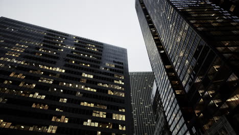 skyscrapers reflect gray sky above a bustling urban landscape during twilight