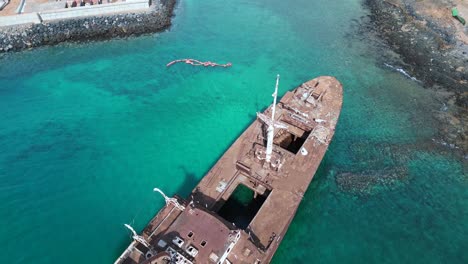Breathtaking-aerial-view-flight-Due-to-run-Shipwreck-on-beach-sandbank-Lanzarote-Canary-Islands,-sunny-day-Spain-2023
