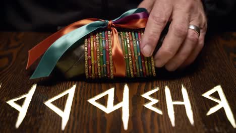 an intriguing unveiling: the ritual of unwrapping a mystical gift with ancient symbols on a rich wooden table surface