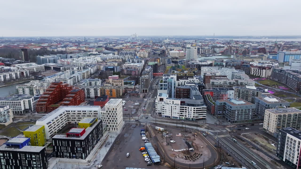 Aerial view backwards over the cityscape of Jatkasaari, cloudy day in Helsinki