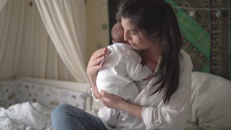 mother embracing newborn baby