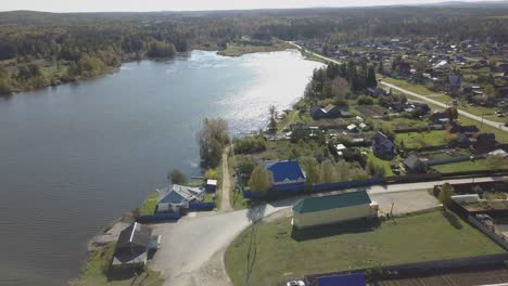 aerial view of a russian village by a lake in autumn