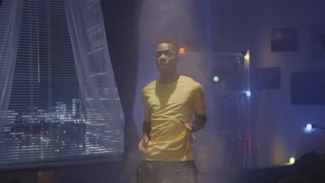 man dancing in his room at night