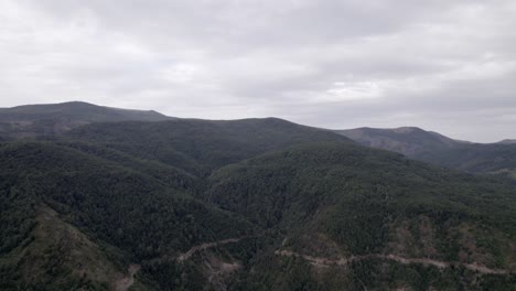 "golden-hour"-head-on-drone-video-moving-over-the-mountains-of-SH22-in-albania,-above-the-road-on-top-of-the-hill