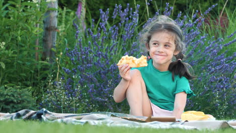 child eating pizza outdoors