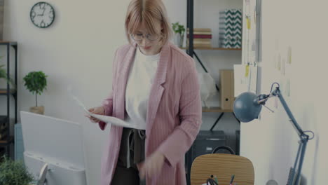 woman reading documents in modern office