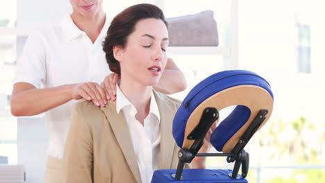 woman having back massage while talking on the phone