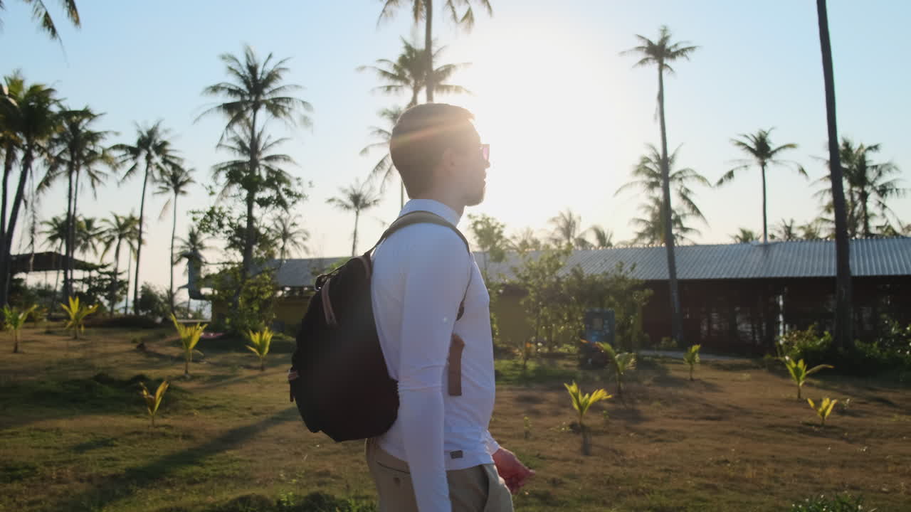 Man Walking Through Tropical Resort
