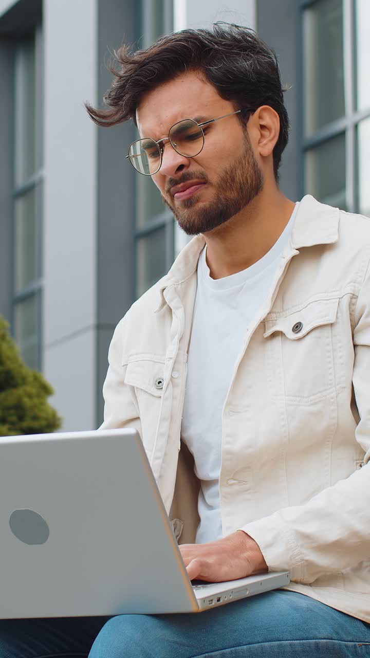 Displeased indian man use laptop surprised by bad news fortune loss game fail lottery results