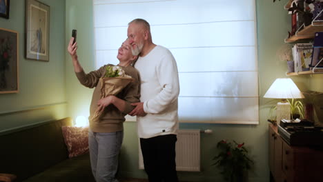 couple taking selfie with flower bouquet