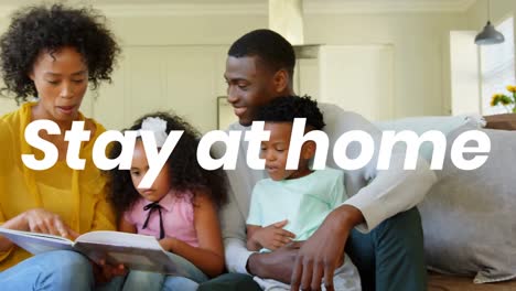 Animation-of-stay-at-home-text-over-parents-with-son-and-daughter-reading-book-at-home