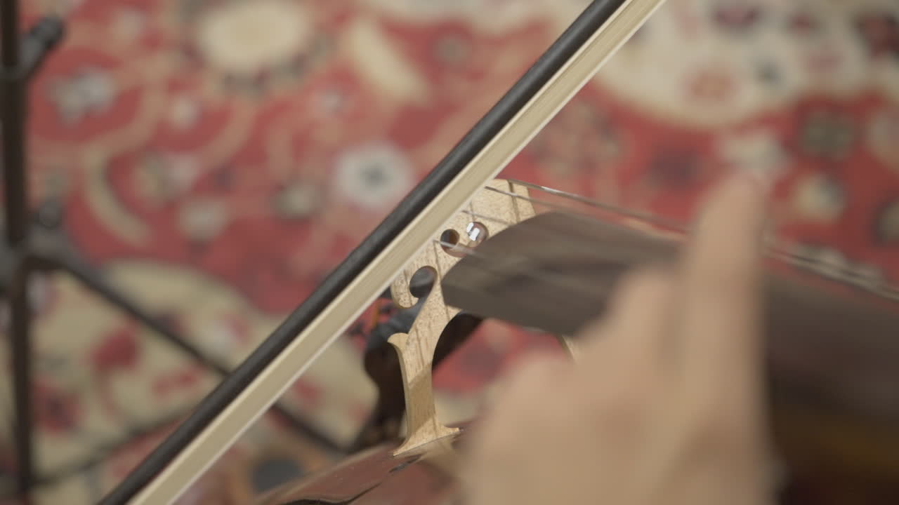 Close-up of Musician's Hand Playing a String Instrument with a Bow
