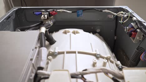 Close up at the interior mechanism of washing machine while it&#039;s working 4k, front view