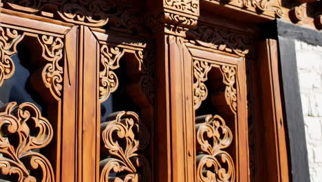 intricate carvings on a traditional wooden window