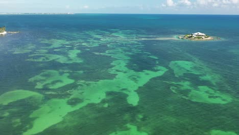 aerial view of a tropical island with clear turquoise water and coral reefs