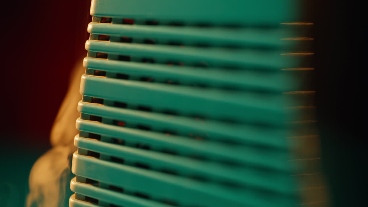 Closeup warm air heater with soft smoke curling gently nearby. Indoor warmth