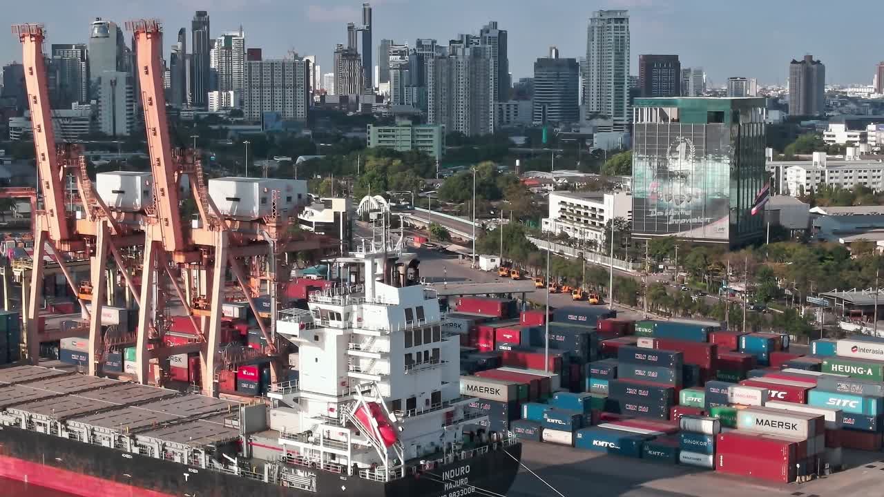 View of Bangkok port with shipping containers and city skyline