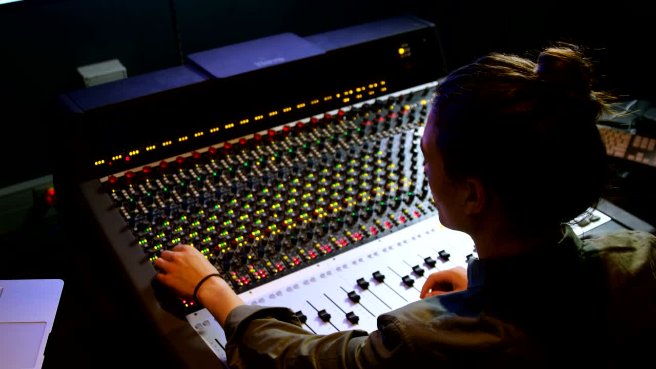 Male audio engineer using sound mixer