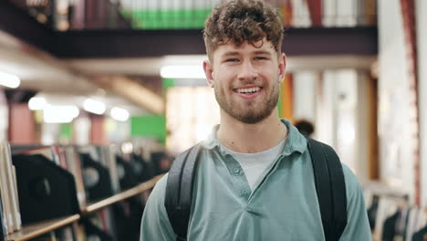 young man smiling in a bookstore